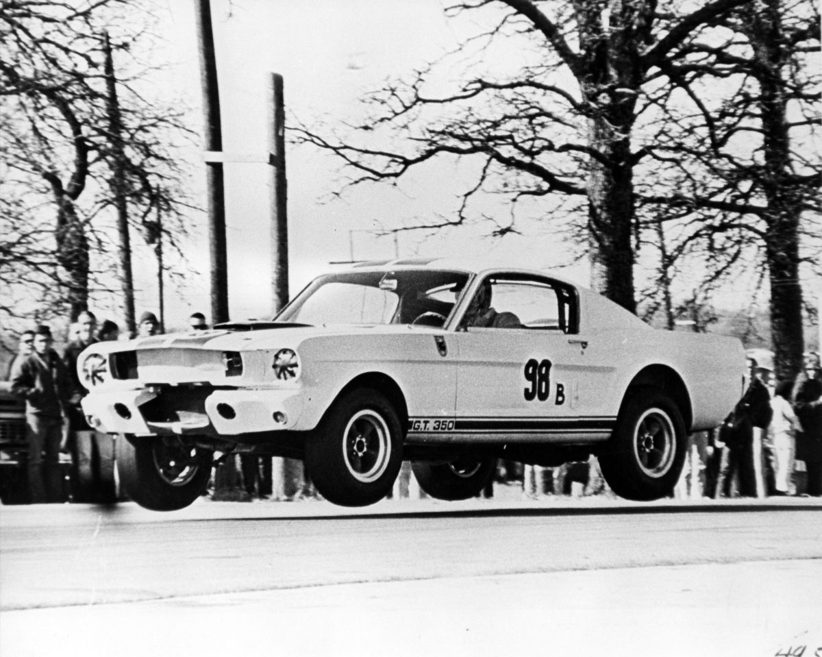 Ken Miles piloting Shelby 5R002 with all four wheels off the ground in February 1965